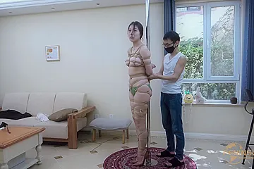 Tied to a pole with dildo gag - porn video